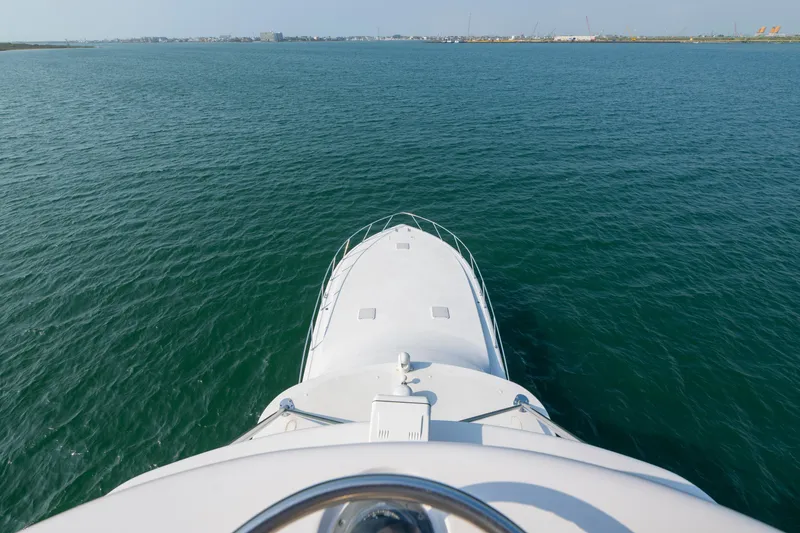 Slide: The Image of Bow view of 2005 Viking Convertible yacht cruising on open water. - 13