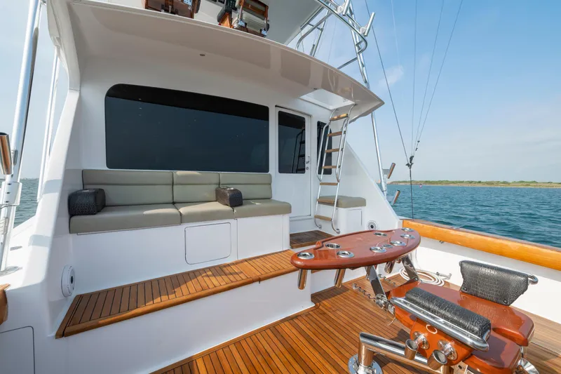 Slide: The Image of 2005 Viking Convertible yacht deck with seating, ladder, and ocean view. - 17