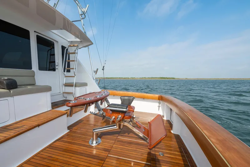 Slide: The Image of 2005 Viking Convertible yacht deck with fishing chair, wooden flooring, and ocean view. - 18