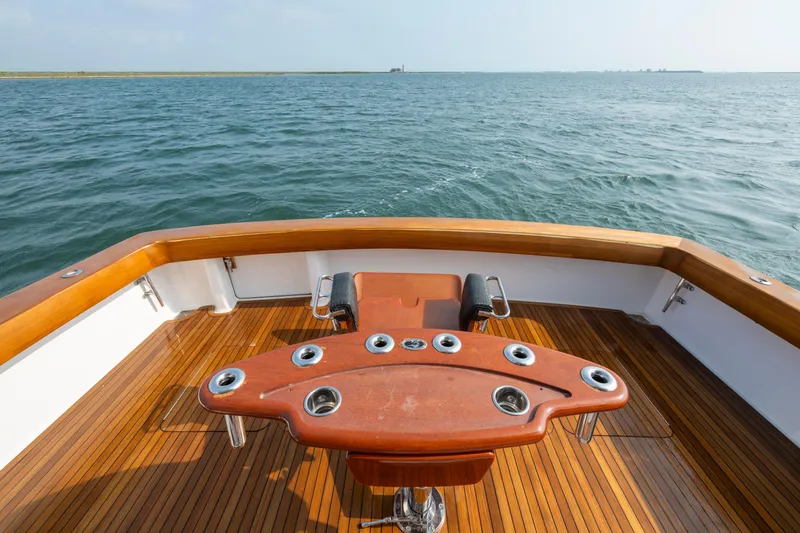 Slide: The Image of 2005 Viking Convertible yacht deck with wooden finish, overlooking the ocean. - 19