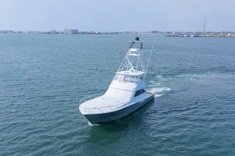 Slide: The Image of 2005 Viking Convertible yacht cruising on open water. - 2