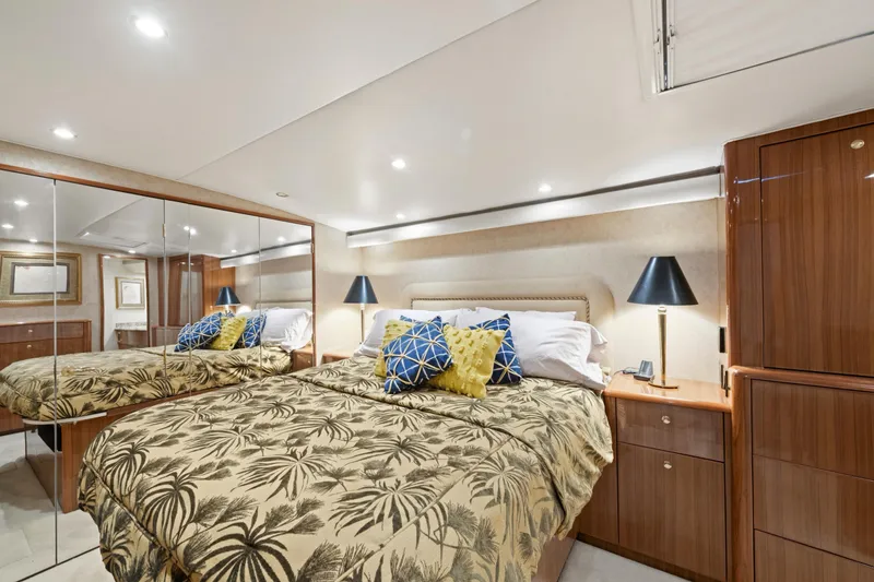 Slide: The Image of Luxurious bedroom interior in a 2005 Viking Convertible yacht with mirrored closet and elegant decor. - 28