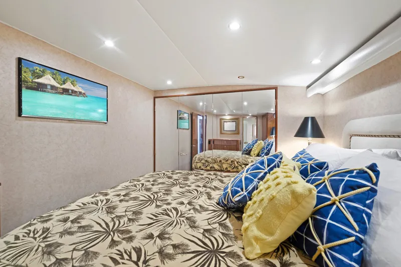 Slide: The Image of Luxurious bedroom interior in a 2005 Viking Convertible yacht, featuring elegant decor and plush bedding. - 30