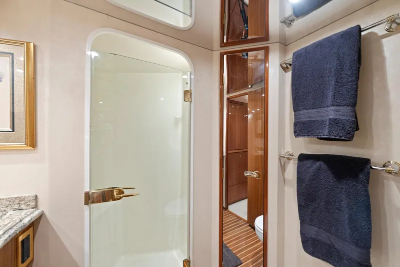 Slide: The Image of Luxurious bathroom in 2005 Viking Convertible yacht with glass shower and plush towels. - 31