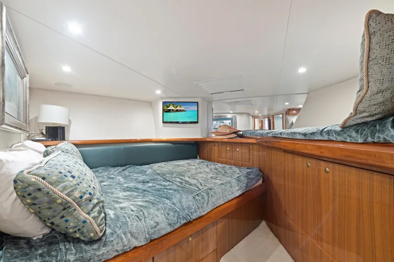 Slide: The Image of Luxurious cabin interior of a 2005 Viking Convertible yacht with cozy bedding and modern amenities. - 33
