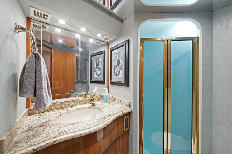 Slide: The Image of Luxurious bathroom in 2005 Viking Convertible yacht with granite countertop and glass shower. - 34