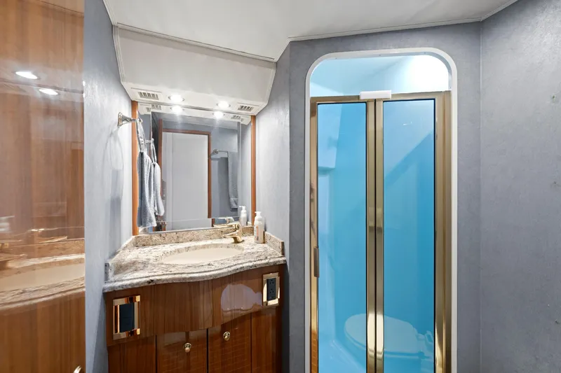 Slide: The Image of Luxurious bathroom in 2005 Viking Convertible yacht with granite countertop and glass shower. - 36