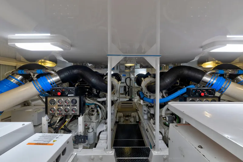 Slide: The Image of Engine room of a 2005 Viking Convertible yacht, featuring complex machinery and control panels. - 38