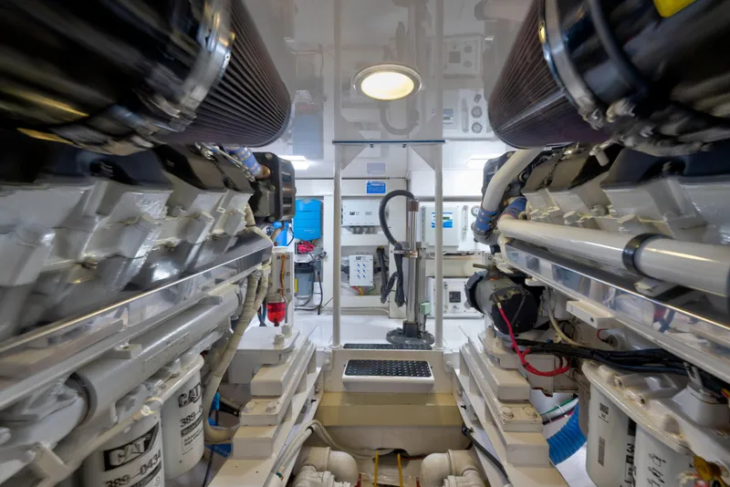 Slide: The Image of Engine room of a 2005 Viking Convertible yacht, showcasing dual engines and mechanical components. - 39