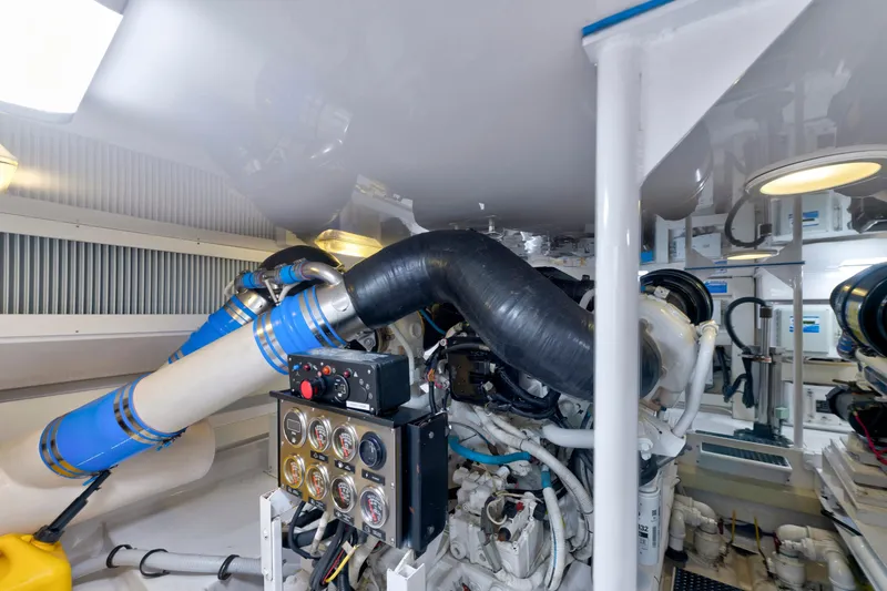 Slide: The Image of Engine room of a 2005 Viking Convertible yacht, showcasing complex machinery and piping. - 40