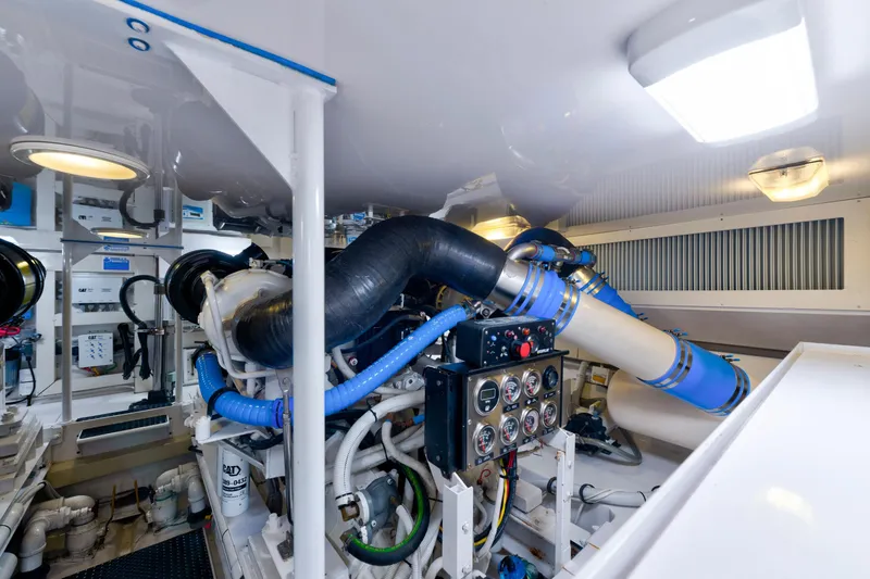 Slide: The Image of Engine room of a 2005 Viking Convertible yacht, featuring complex machinery and control panels. - 41