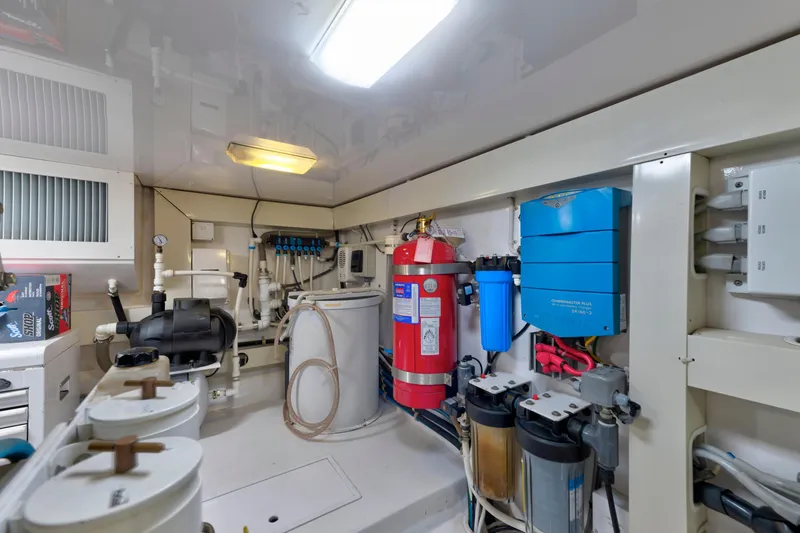 Slide: The Image of Engine room of a 2005 Viking Convertible yacht with equipment and fire extinguisher. - 42