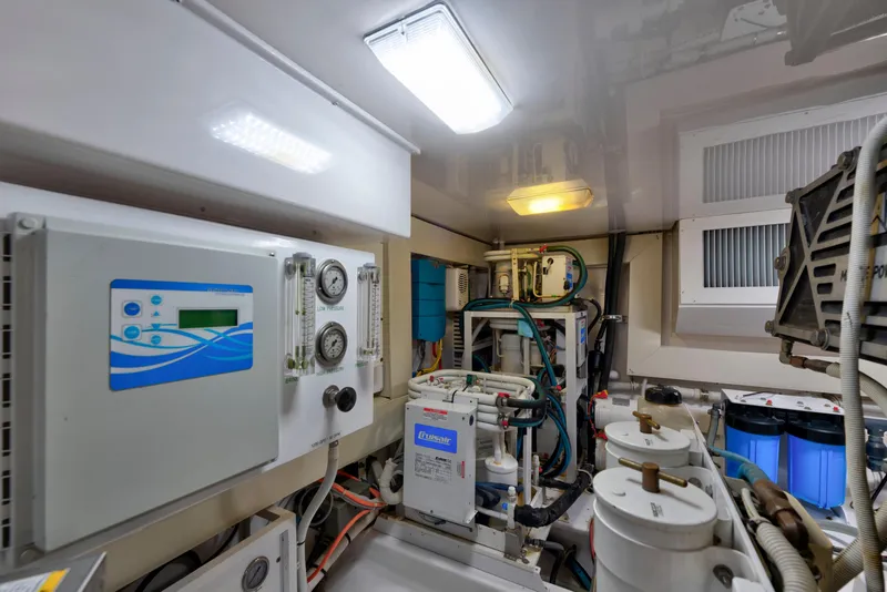 Slide: The Image of Engine room of a 2005 Viking Convertible yacht, featuring advanced machinery and control panels. - 43