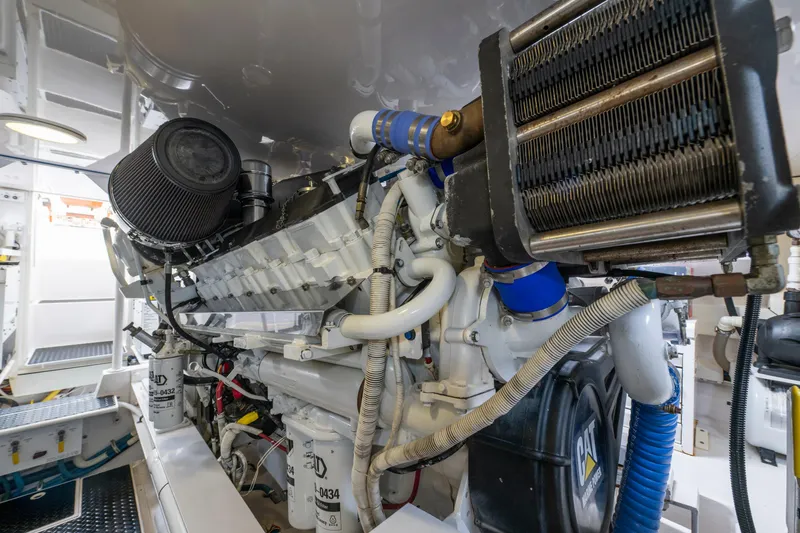 Slide: The Image of Engine room of a 2005 Viking Convertible yacht, showcasing detailed machinery components. - 44