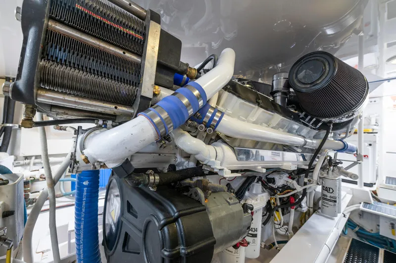 Slide: The Image of Engine room of a 2005 Viking Convertible yacht, showcasing intricate machinery and components. - 45