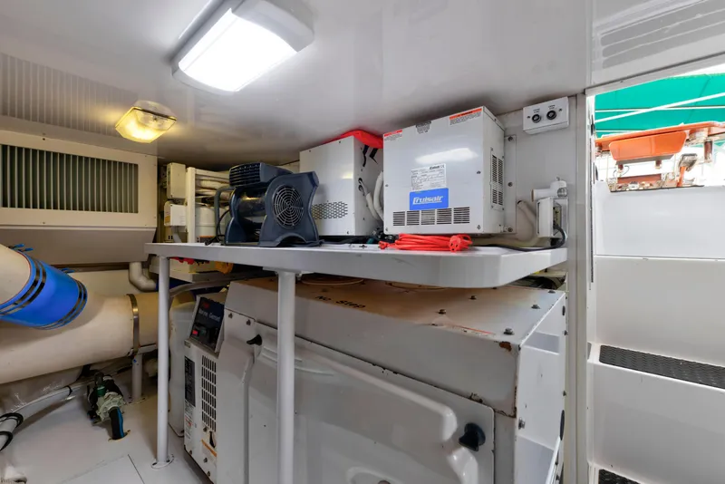 Slide: The Image of Engine room of a 2005 Viking Convertible yacht with equipment and ventilation systems. - 46