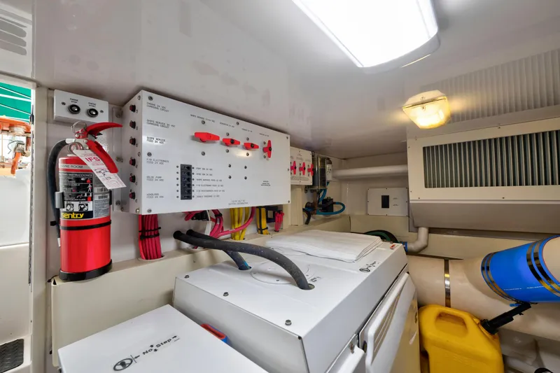 Slide: The Image of Electrical panel and equipment inside a 2005 Viking Convertible boat engine room. - 47