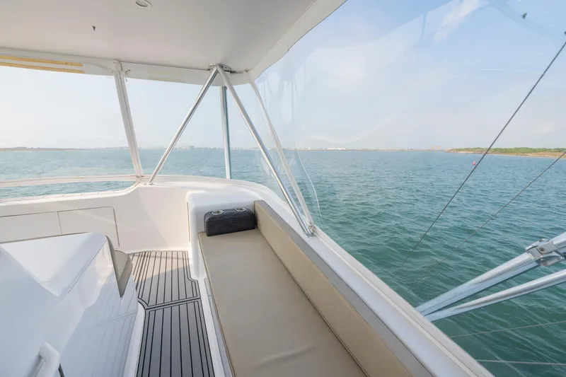 Slide: The Image of 2005 Viking Convertible yacht interior with ocean view, featuring sleek seating and modern design. - 8