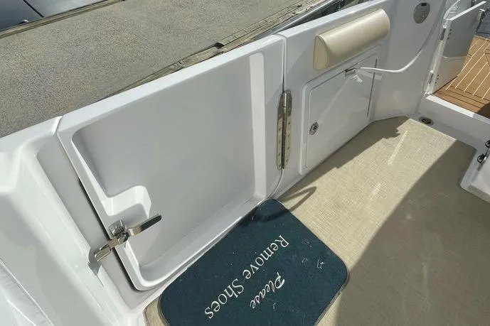 Slide: The Image of 2022 Southport 33 DC boat interior with "Please Remove Shoes" mat. - 14