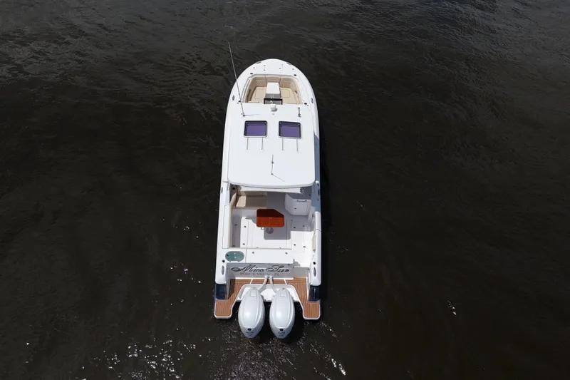 Slide: The Image of Aerial view of 2022 Southport 33 DC boat on dark water. - 24
