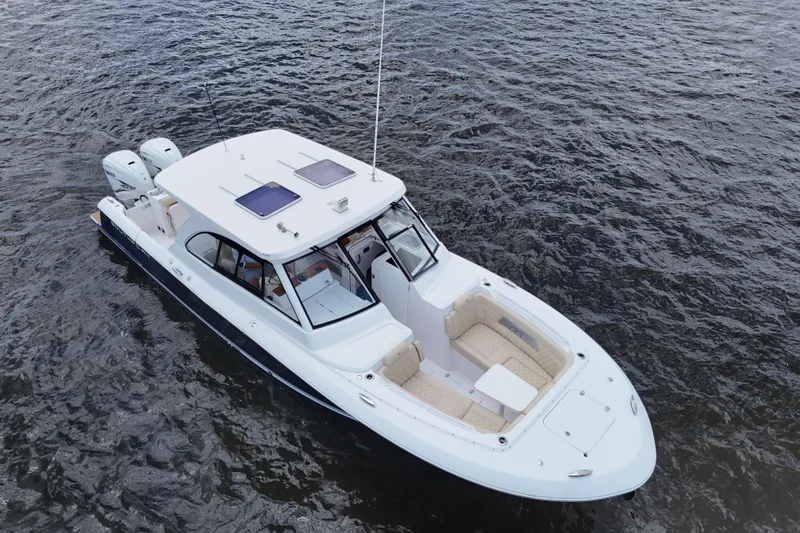 Slide: The Image of 2022 Southport 33 DC boat on water, featuring sleek design and dual engines. - 22