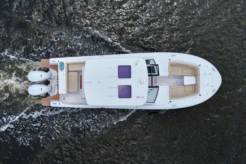 Slide: The Image of Aerial view of 2022 Southport 33 DC boat cruising on water. - 23