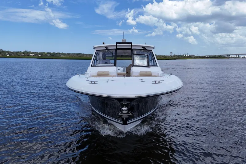 Slide: The Image of 2022 Southport 33 DC boat cruising on a calm waterway under a partly cloudy sky. - 18