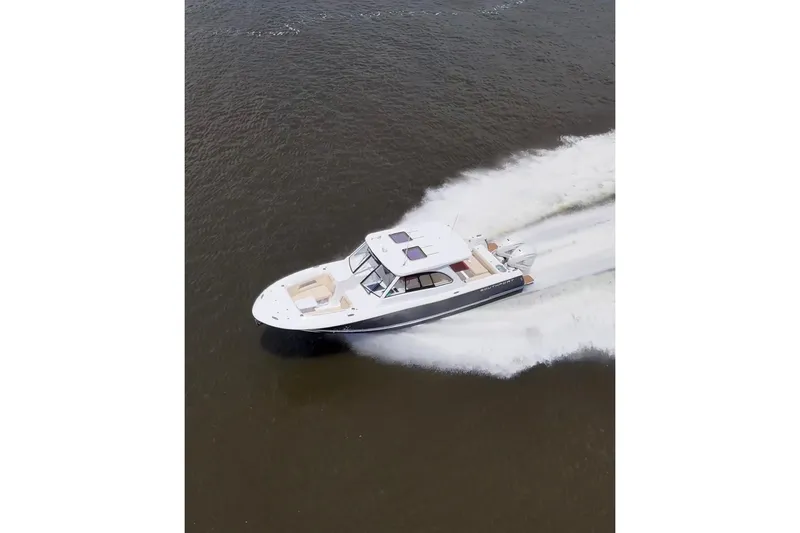 Slide: The Image of 2022 Southport 33 DC boat cruising swiftly on open water. - 7