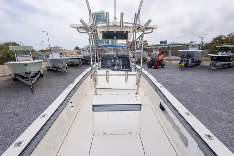 Slide: The Image of 1997 Sea Cat SL5 boat on display, surrounded by other boats and equipment in a lot. - 10