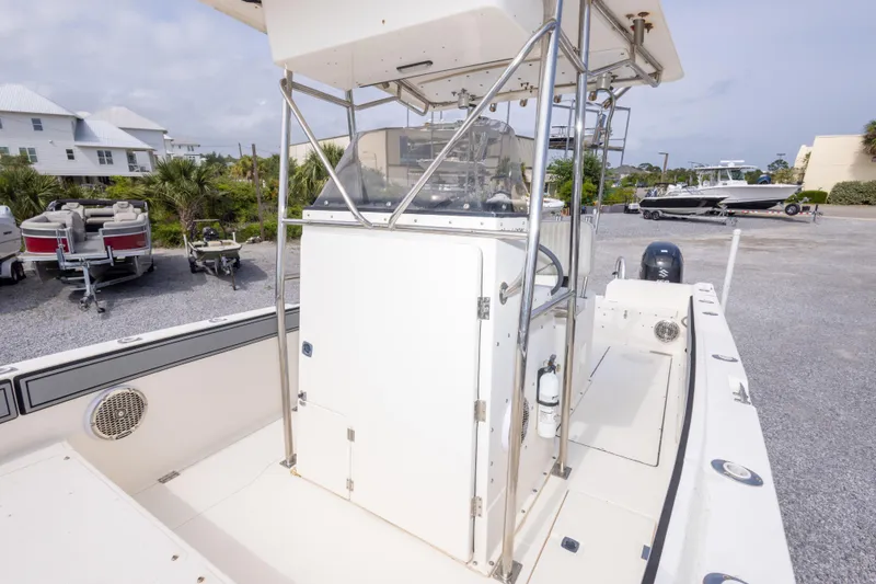 Slide: The Image of 1997 Sea Cat SL5 boat with center console, parked outdoors on a sunny day. - 11