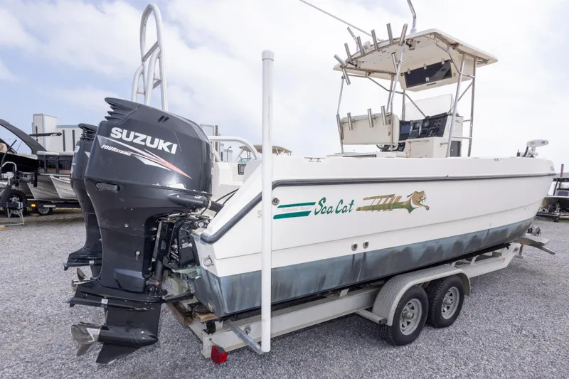 Slide: The Image of 1997 Sea Cat SL5 boat with Suzuki outboard motor on a trailer. - 12