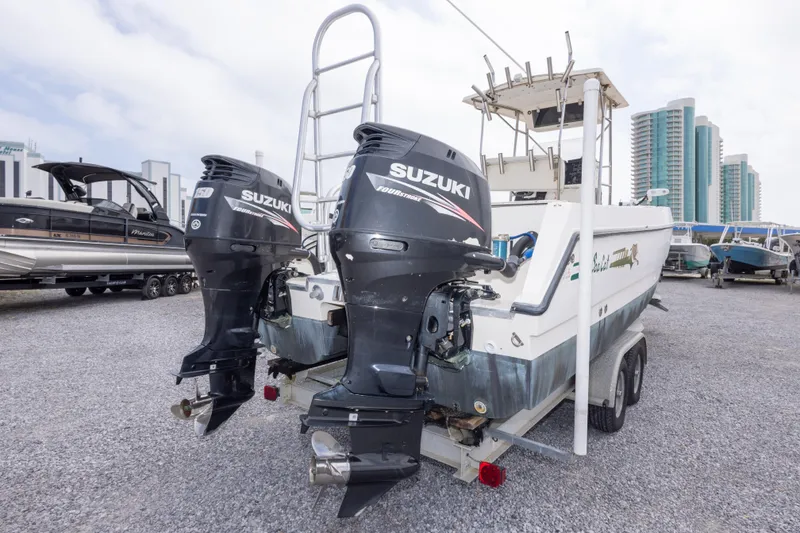 Slide: The Image of 1997 Sea Cat SL5 boat with dual Suzuki outboard motors on a trailer. - 13