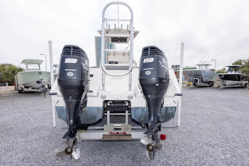 Slide: The Image of Rear view of a 1997 Sea Cat SL5 boat with dual outboard motors. - 14