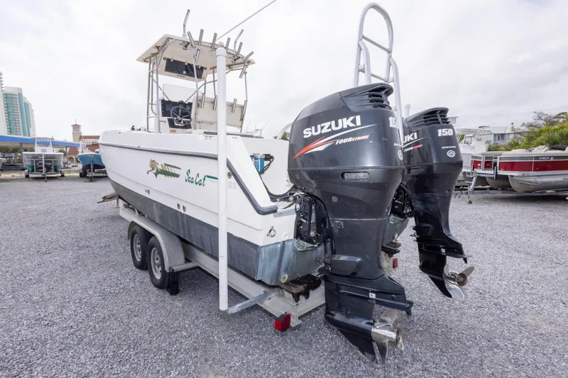 Slide: The Image of 1997 Sea Cat SL5 boat with twin Suzuki 150 outboard motors on a trailer. - 15