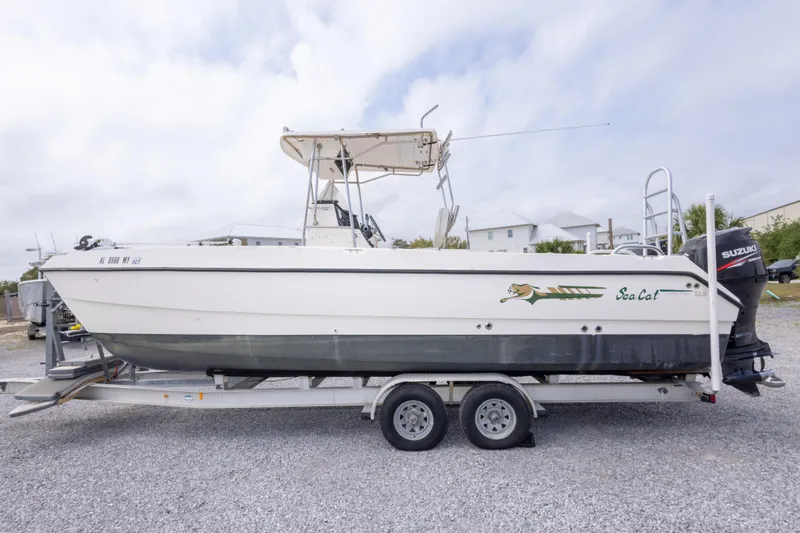 Slide: The Image of 1997 Sea Cat SL5 boat on trailer with Suzuki outboard motor. - 16