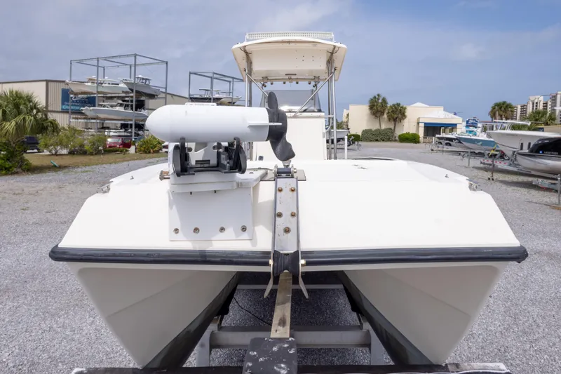 Slide: The Image of 1997 Sea Cat SL5 boat on trailer, outdoor storage area, clear sky background. - 17