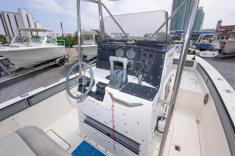 Slide: The Image of 1997 Sea Cat SL5 boat cockpit with steering wheel and control panel, docked near other boats. - 20