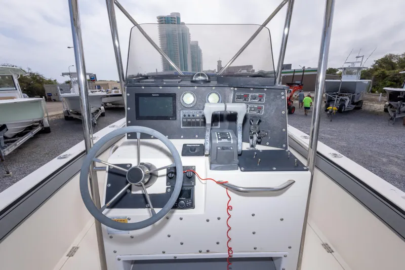 Slide: The Image of 1997 Sea Cat SL5 boat dashboard with steering wheel and control panel. - 23