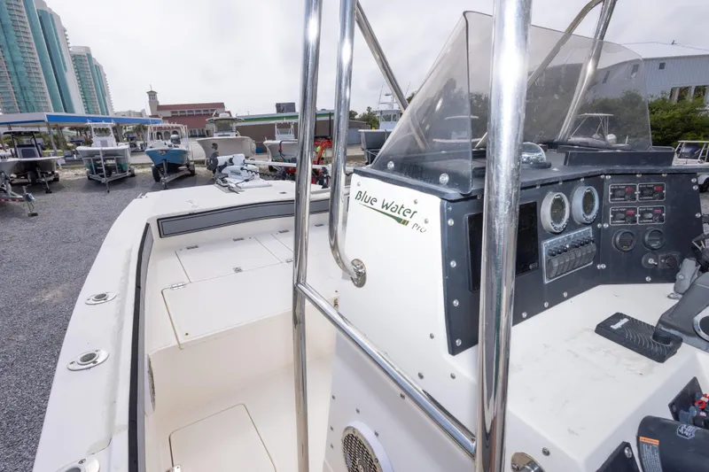 Slide: The Image of 1997 Sea Cat SL5 boat dashboard with controls, parked among other boats. - 24