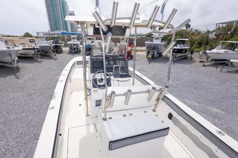 Slide: The Image of 1997 Sea Cat SL5 boat with center console and rod holders in a marina. - 8