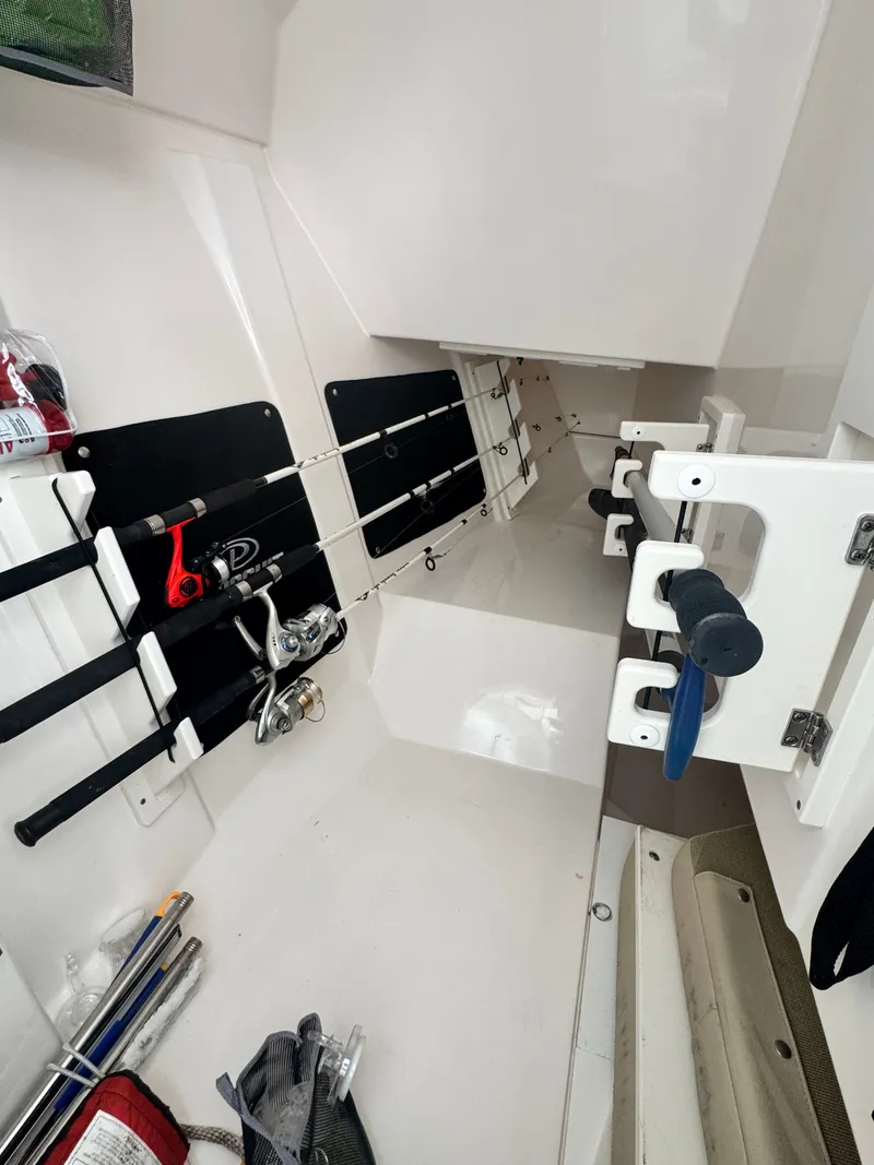 Slide: The Image of Interior of 2017 Pursuit DC 295 Dual Console with fishing rod holder. - 14