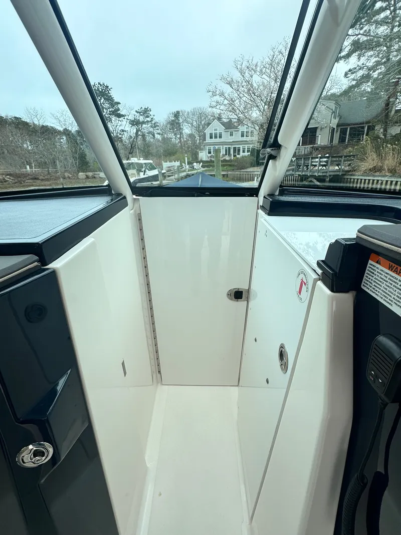 Slide: The Image of Interior view of a 2017 Pursuit DC 295 Dual Console boat. - 16