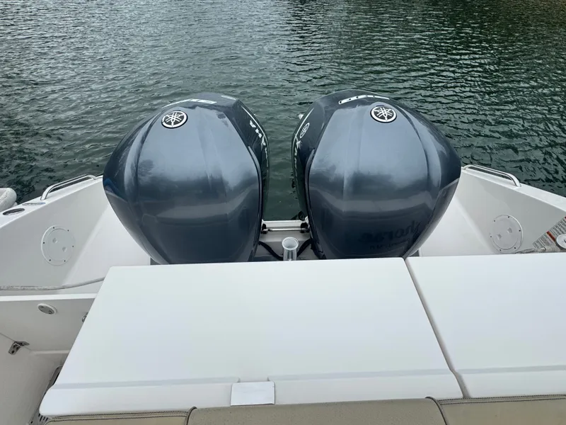 Slide: The Image of 2017 Pursuit DC 295 Dual Console with twin outboard engines. - 6