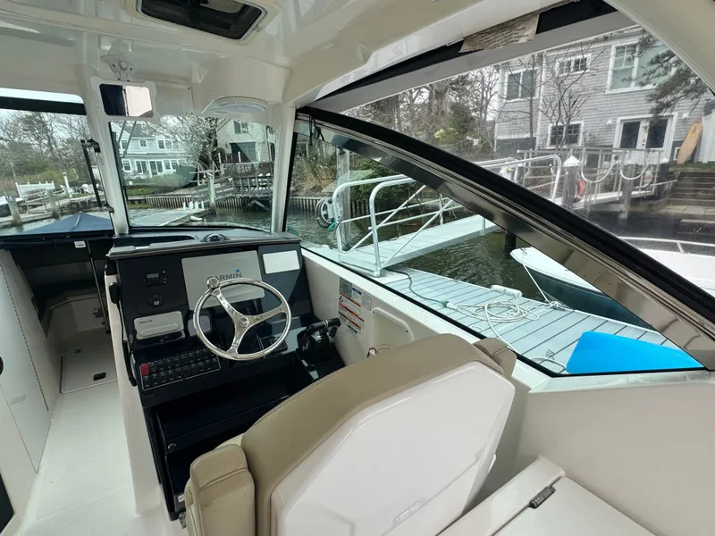 Slide: The Image of Interior of a 2017 Pursuit DC 295 Dual Console at dock. - 9