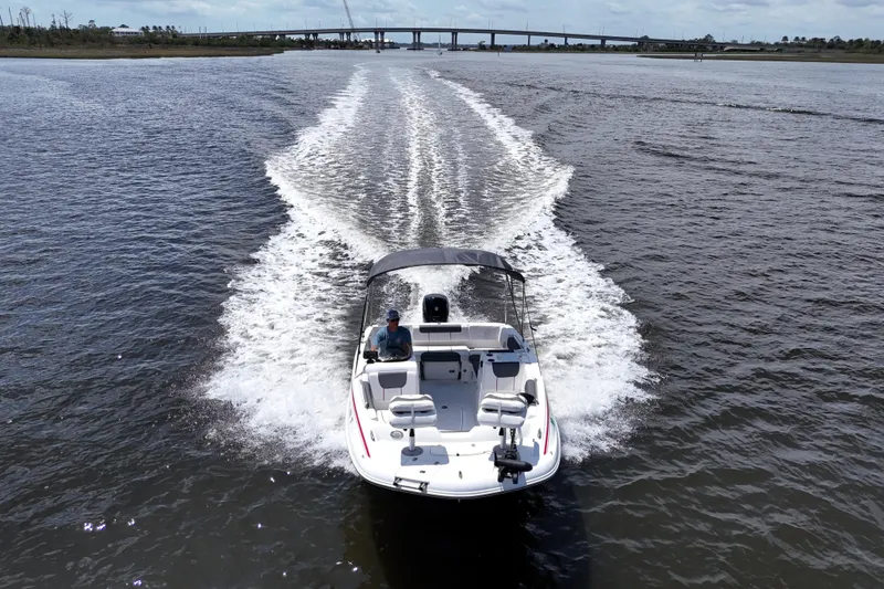 Slide: The Image of 2022 Tahoe 1950 boat cruising on open water with bridge in background. - 15