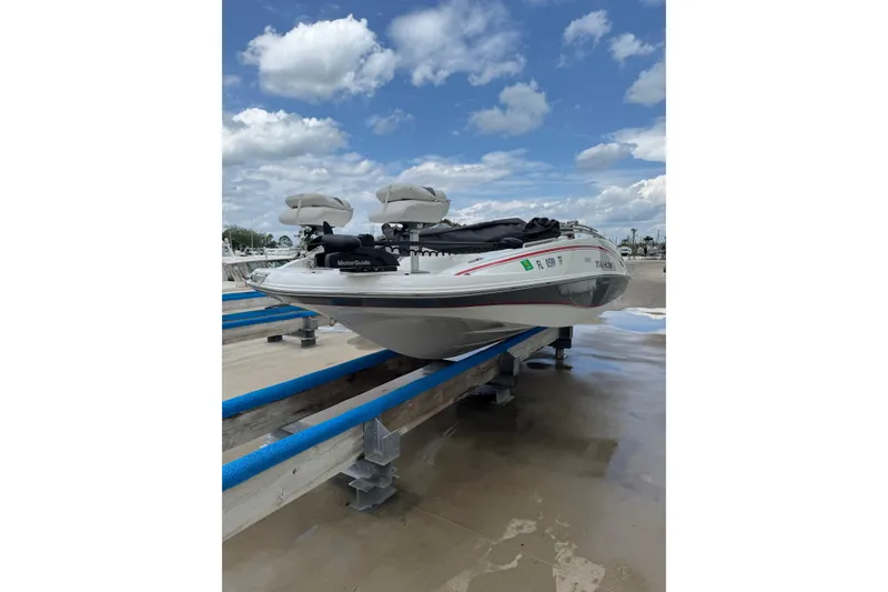 Slide: The Image of 2022 Tahoe 1950 boat on dock under blue sky with clouds. - 27