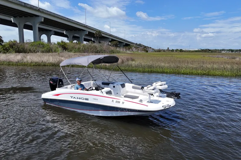 Slide: The Image of Boat on water under bridge, Tahoe 1950 model, 2022, with canopy and motor. - 7