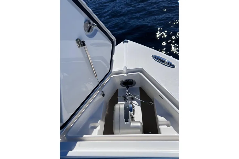 Slide: The Image of Open anchor compartment on 2021 Jupiter 34 boat, with ocean in background. - 11
