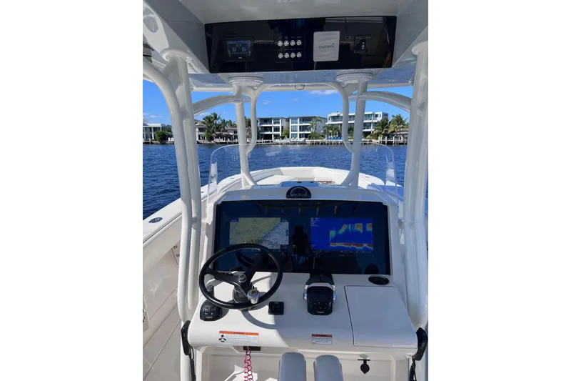 Slide: The Image of Helm of 2021 Jupiter 34 boat with navigation screens and steering wheel. - 6