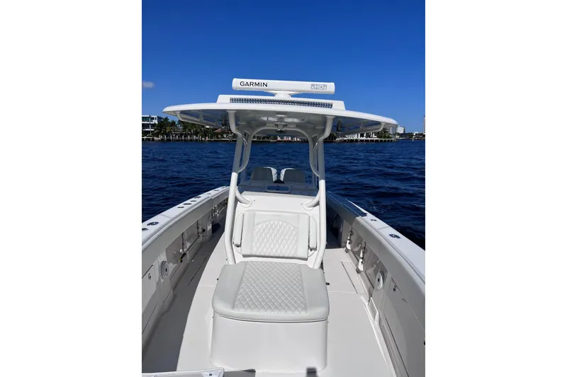 Slide: The Image of 2021 Jupiter 34 boat on water, featuring Garmin equipment and sleek white seating. - 9